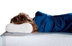 Woman laying on Tempur-neck pillow on a Tempur-Pedic mattress