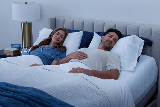 Man and woman asleep on ActiveBreeze bed